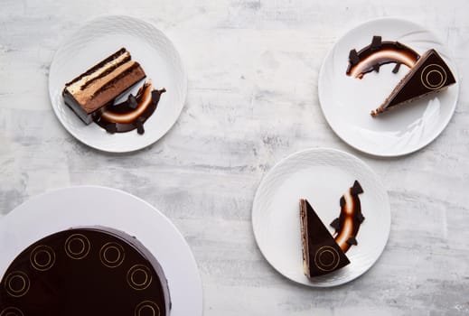 A top view shot of a chocolate cake slices on a white plate