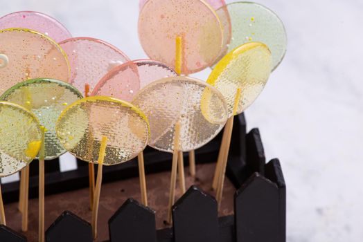 A close-up shot of a whole brownie decorated with glass lollypops.