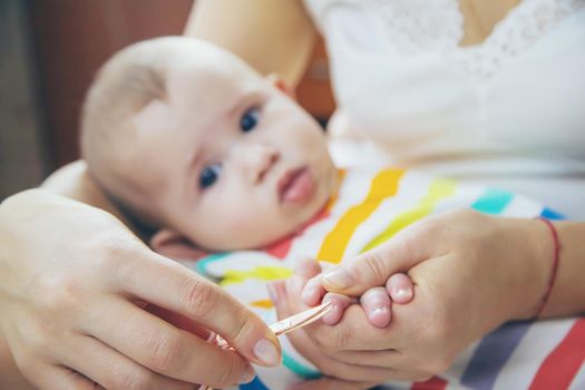 mother cuts little baby's nails. Selective focus. Child.