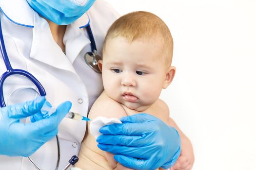 Vaccination of a baby by a doctor in a hospital. Selective focus. medicine.