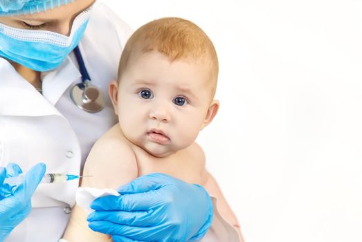 Vaccination of a baby by a doctor in a hospital. Selective focus. medicine.