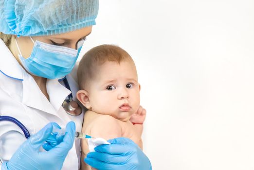 Vaccination of a baby by a doctor in a hospital. Selective focus. medicine.