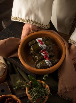 A close up shot of a dolma covered in grape leaves