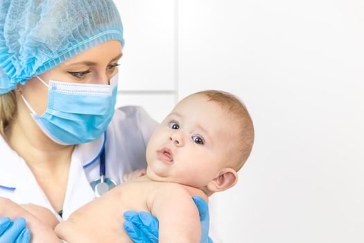 The baby is examined by a pediatrician at the hospital. Selective focus. people.