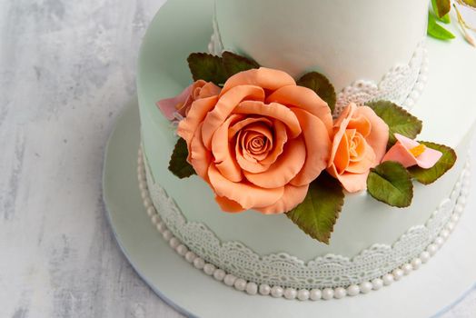 A close up shot of designed rose flowers on a white cake.