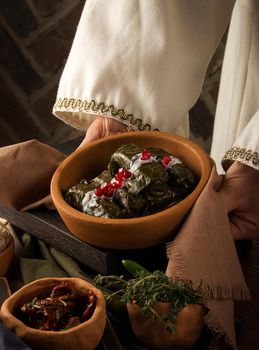 A close up shot of a dolma covered in grape leaves