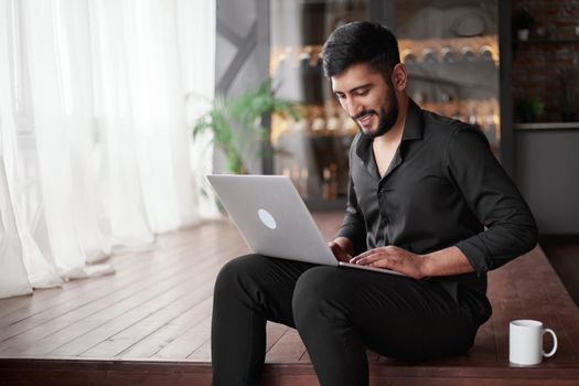 business owner using a laptop in his new store. concept of wireless technologies.