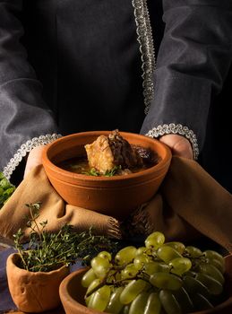 A vertical shot of a chef serving a gourmet dish