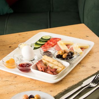 A closeup shot of a breakfast white plate on a wooden table