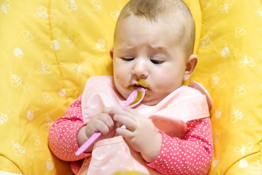 Baby is eating vegetable puree. Selective focus. Food.