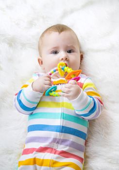 The mother gives a rattle to the baby. Selective focus. child.