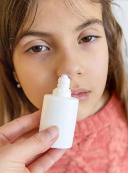 Mother drips medicine into the child nose. Selective focus. People.