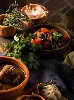 A vertical shot of a chef serving a gourmet salad dish