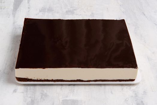 A closeup shot of a chocolate cake on a white plate