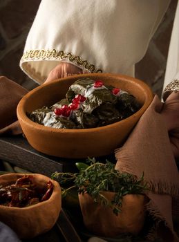 A close up shot of a dolma covered in grape leaves