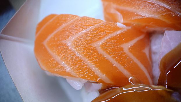 Traditional Japanese food sushi rolls of red fish in a box.View from above.Texture or background