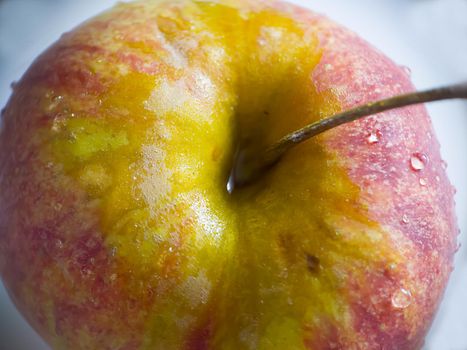 Macro.A red-yellow apple with water droplets on the surface.Texture or background