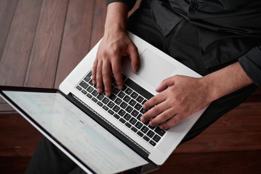 close-up. cropped image of a businessman with a laptop sitting on the floor. startup concept.