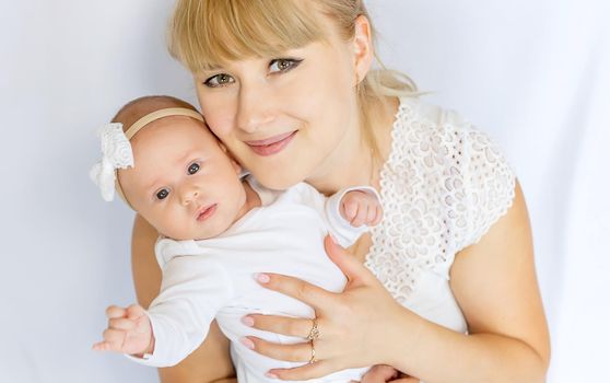 Mom is holding a newborn baby. Selective focus. People.