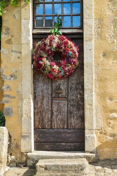 Multi-colored hydrangea wreath on a wooden vintage door