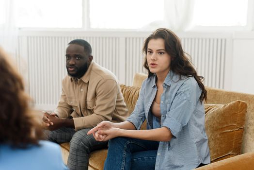 A diverse couple came to a session with a psychologist. Relationship problems, avoiding divorce.