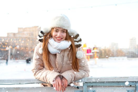 Beautiful lovely young woman long hair warm winter jackets funny fluffy hat stands outdoor on city street. Christmas mood lifestyle Happy holiday woman walk snowy day Winter leisure