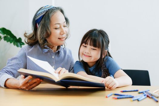 Asian portrait, grandchild granddaughter grandma grandmother and granddaughter happily join in activities to enhance skills for grandchildren.