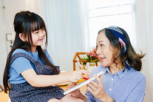 Asian portrait, grandchild granddaughter grandma grandmother and granddaughter happily join in activities to enhance skills for grandchildren.