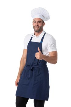 Portrait of happy young cook in uniform standing isolated over white background. Looking camera showing thumbs up.