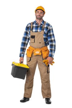 Contractor worker in coveralls and yellow hardhat with toolbox isolated on white background, full length portrait