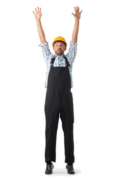 Portrait of confident male repairman contractor worker in coveralls and yellow hardhat standing with arms raised isolated on white background