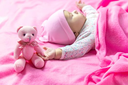 Baby sleeps with a bear. Selective focus. people.