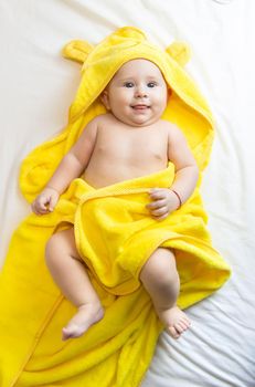 Little baby in a towel after bathing. Selective focus. People.