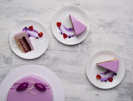 A top view shot of purple cake sliced on a white plates