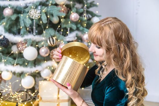 The girl opens Christmas presents. Selective focus. Holiday.