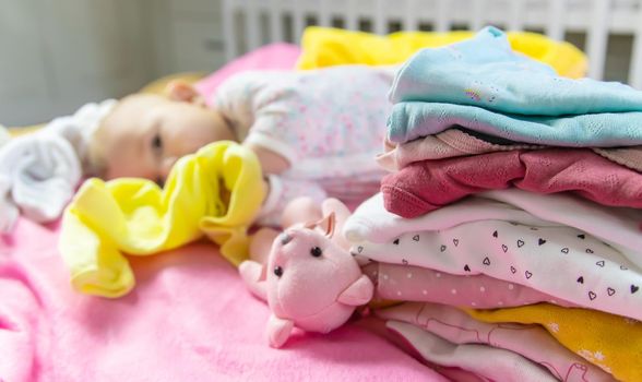Baby scattered clothes and toys. Selective focus. people.