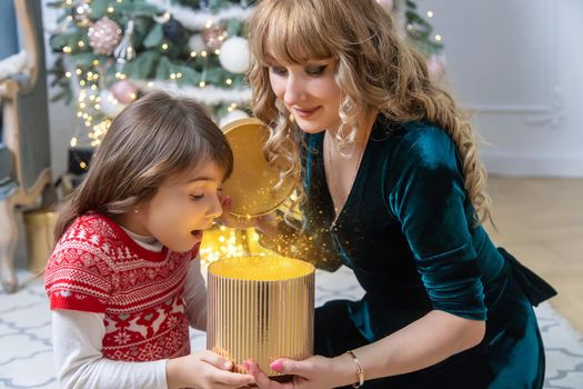 Child girl parents give presents for christmas. Selective focus. Holiday.