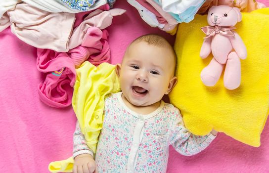 Baby scattered clothes and toys. Selective focus. people.