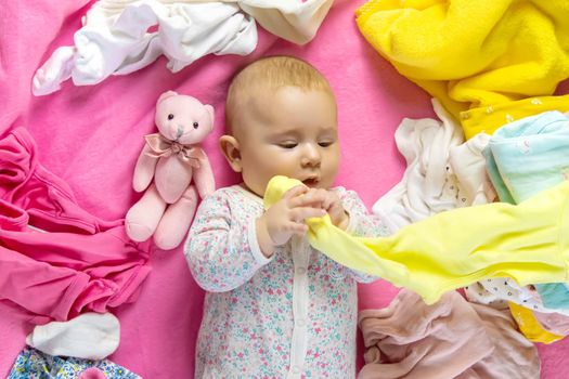 Baby scattered clothes and toys. Selective focus. people.