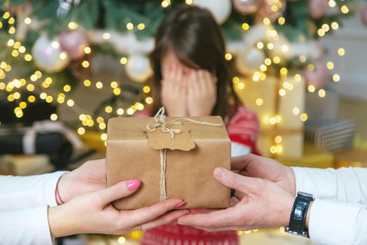 Child girl parents give presents for christmas. Selective focus. Holiday.