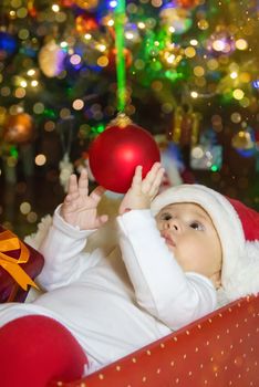 Baby is under the tree, Christmas. Selective focus. Holiday.
