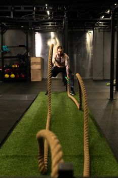 Rope man grass warehouse green fitness training gym exercising exercise, for athlete one from male from healthy moving, sport muscle. Standing ground holding, lifestyles