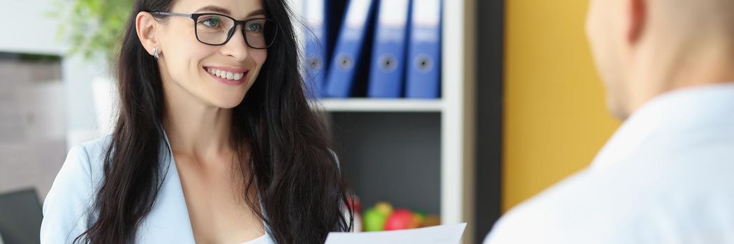 Portrait of smiling confident businesswoman hire man on work go through his cv. Man applied for vacant position in company. Hr, boss, start career concept