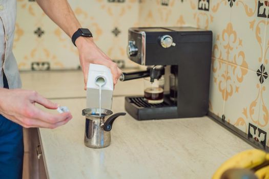 Handsome man using coffee machine in kitchen.