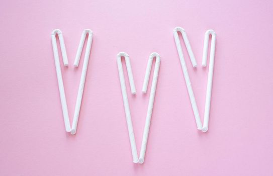 Cocktail Straws Day. Paper drinking straws on a pink background. Summer cocktail party, a fun and cheerful holiday concept.