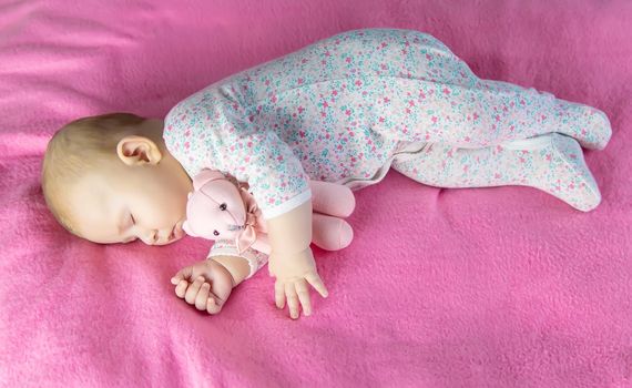 Baby sleeps with a bear. Selective focus. people.