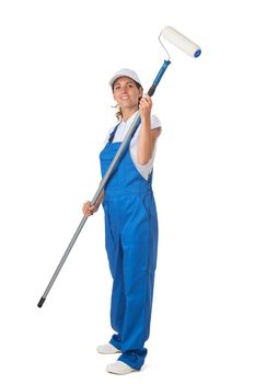 Female house painter in blue coveralls with paint roller tool isolated on white background