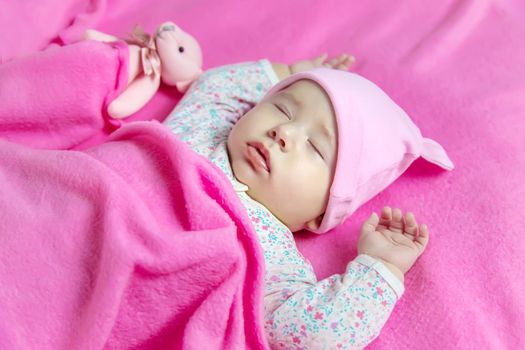 Baby sleeps with a bear. Selective focus. people.