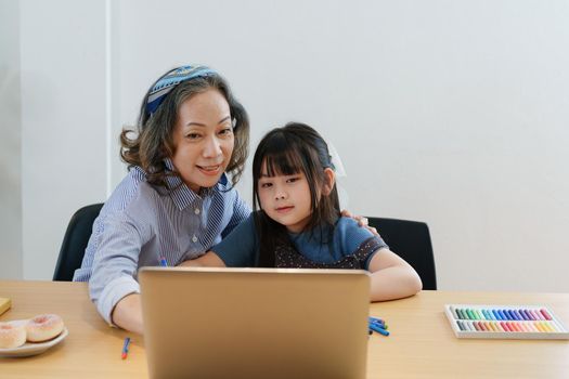 Asian portrait, grandchild granddaughter grandma grandmother and granddaughter happily join in activities to enhance skills for grandchildren.