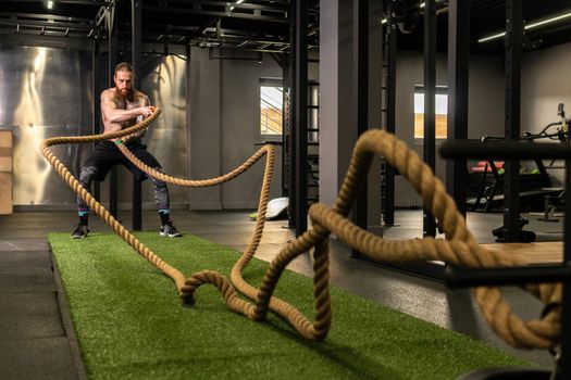 Rope man grass warehouse green fitness training gym exercising exercise, for athlete one from male from healthy moving, sport muscle. Standing ground holding, lifestyles